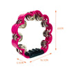 A bright pink petal-shaped hand-cranked tambourine with a silver grip shown against a white background.