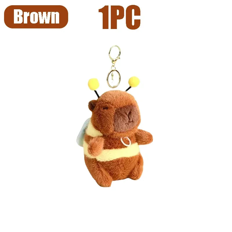 Brown capybara plush toy with yellow accents and a silver keychain ring.
