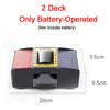 A black automatic card shuffler device with a clear window and decorative card inserts shown from the top view.