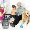 A woman and a dog are sitting on a couch with a canvas knitting tote bag and yarn storage visible.