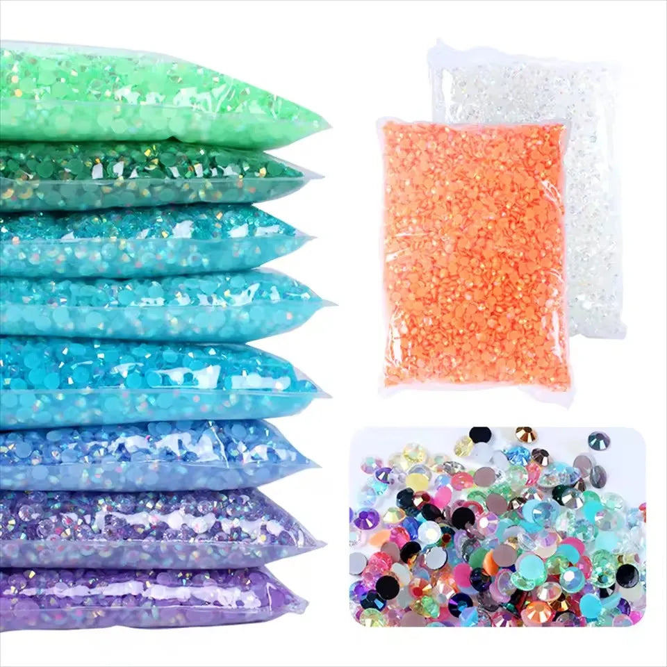 A collection of flat back resin rhinestones in various colors including green, blue, purple, and orange.
