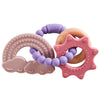 A set of food-grade silicone planet teethers in purple and pink colors.