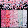 A collection of pink and white AB resin rhinestones and pearls in various sizes and shades for DIY crafts.