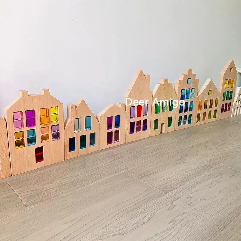 A row of wooden building blocks shaped like houses with colorful acrylic window panes.