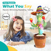 A smiling young girl is interacting with an interactive talking cactus toy wearing a sombrero.