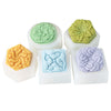 A set of silicone flower molds in green, yellow, blue, and purple for soap, candle, and craft projects.