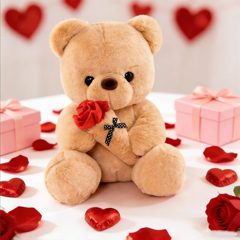 A fluffy brown plush bear sitting on a white surface surrounded by red rose petals and gift boxes.