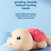 A light pink turtle-shaped water gun is shown against a soft blue background.