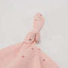 A pink knitted baby hat with a bow detail and small heart patterns.