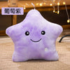A purple star-shaped plush pillow with a smiling face and an attached light.