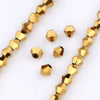 A close-up of gold-toned faceted crystal beads arranged in strands for jewelry making.