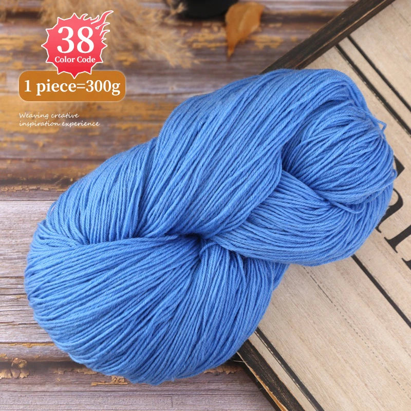 A skein of bright blue premium alpaca blend yarn is shown coiled on a wooden surface.