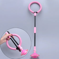 A pink glowing skip ball for kids with a handle and floatable base is shown against a gray background.