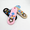Three silicone teething remote control toys in pink, blue, and beige colors are displayed on a white background.