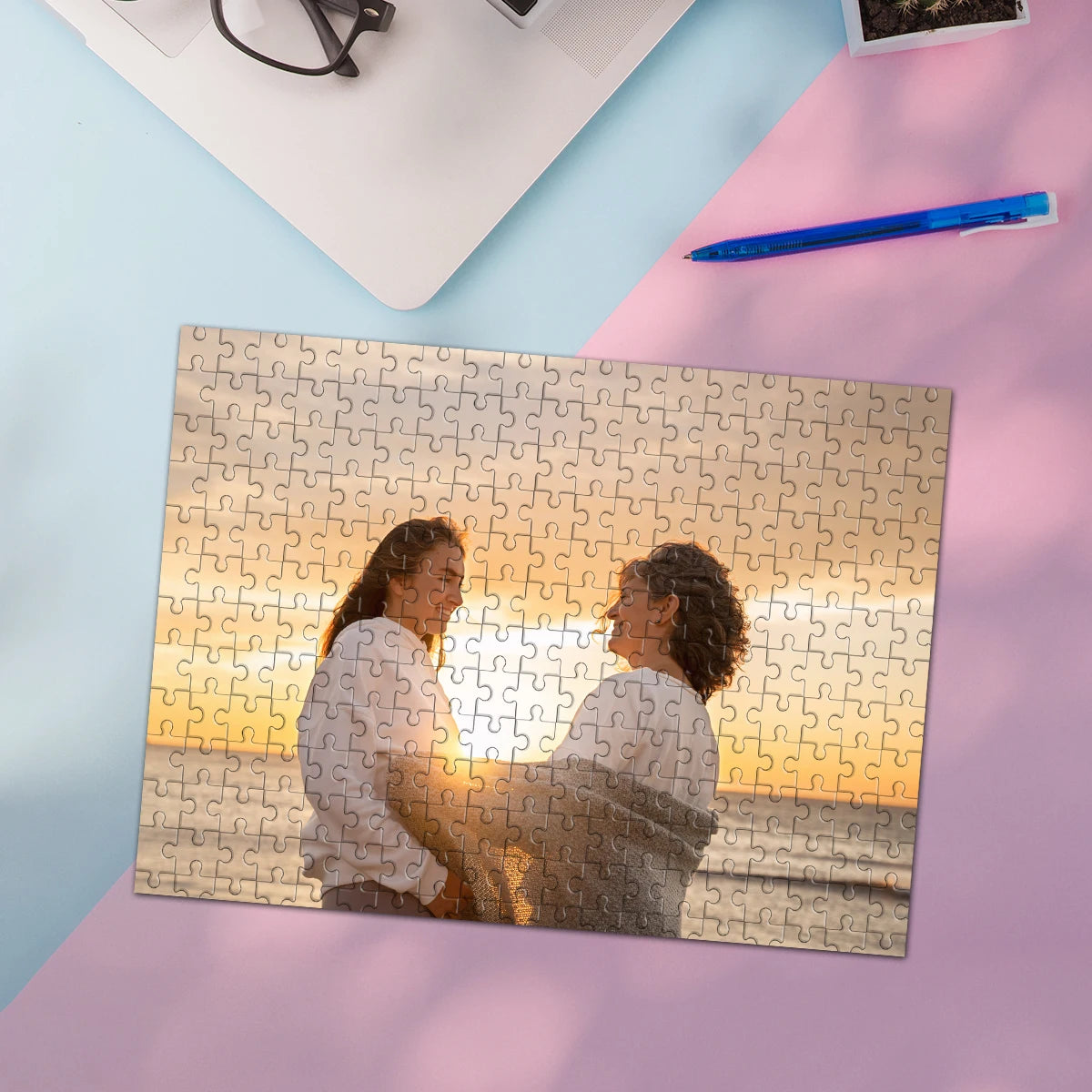 A jigsaw puzzle featuring a photo of two people looking at each other, set on a pink surface.