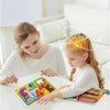 A young girl and woman are playing with a wooden tangram puzzle set featuring animals, vehicles, and sea life.