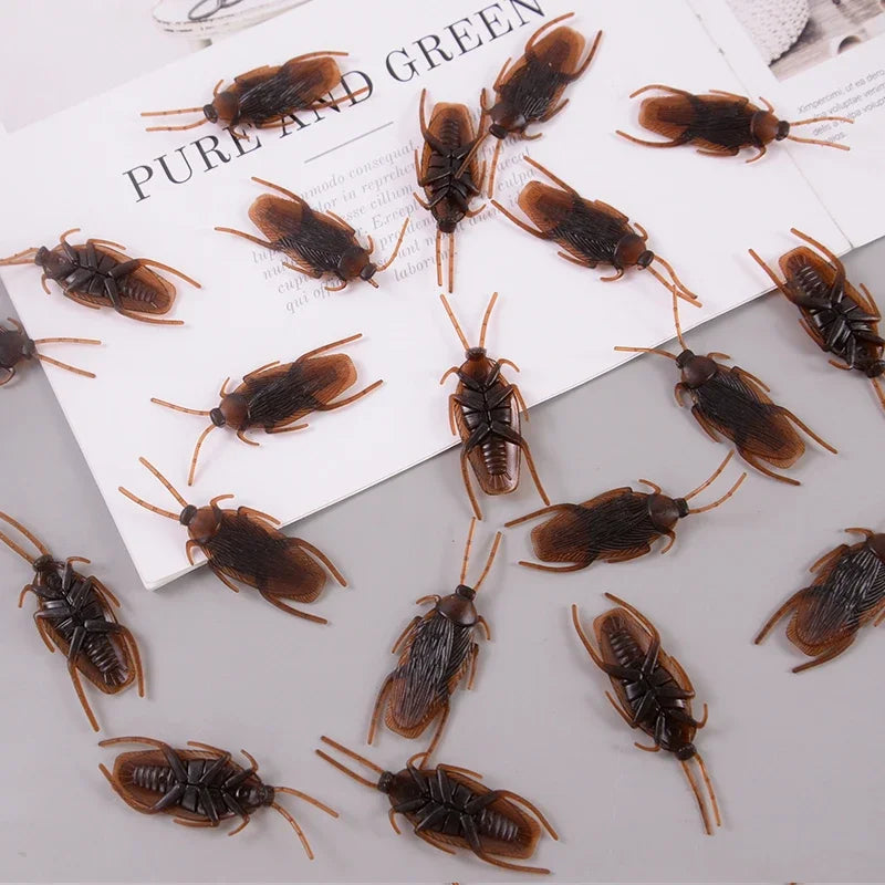 A collection of lifelike fake cockroaches in various shades of brown and black.