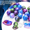 A collection of iridescent, colorful slime balls in various shades of blue, purple, and green are displayed on a white surfac