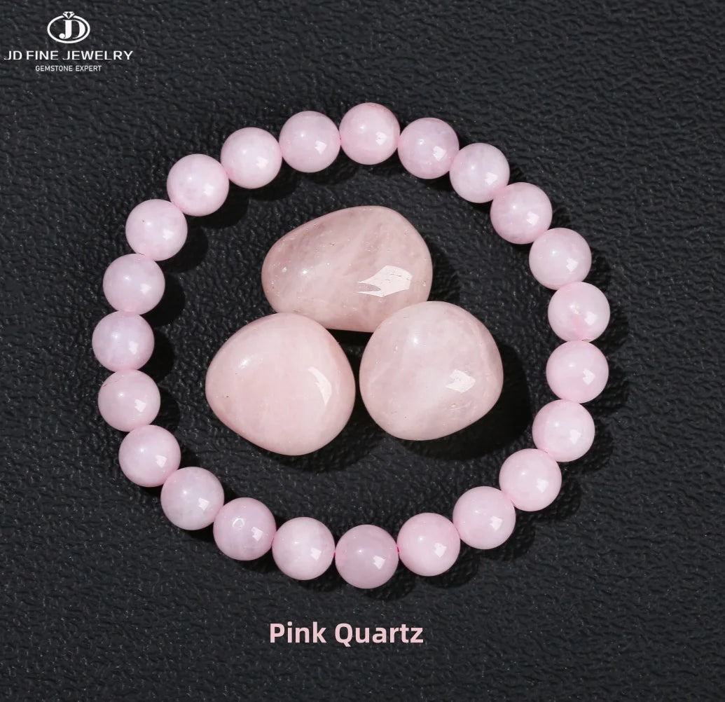A bracelet made of round pink quartz beads encircling a larger central stone.