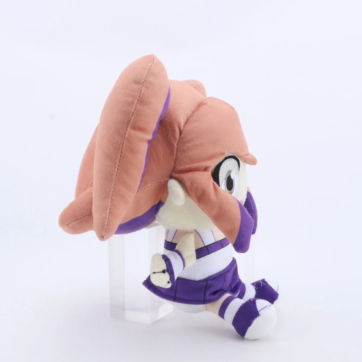 A plush toy of Lyna featuring pink hair and purple clothing.