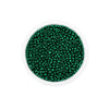 A clear container filled with small, round, green glass seed beads for jewelry making.