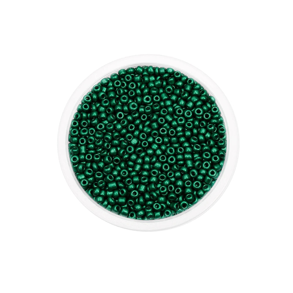 A clear container filled with small, round, green glass seed beads for jewelry making.