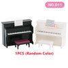 A black miniature piano with a matching bench and a white miniature piano with a matching stool.
