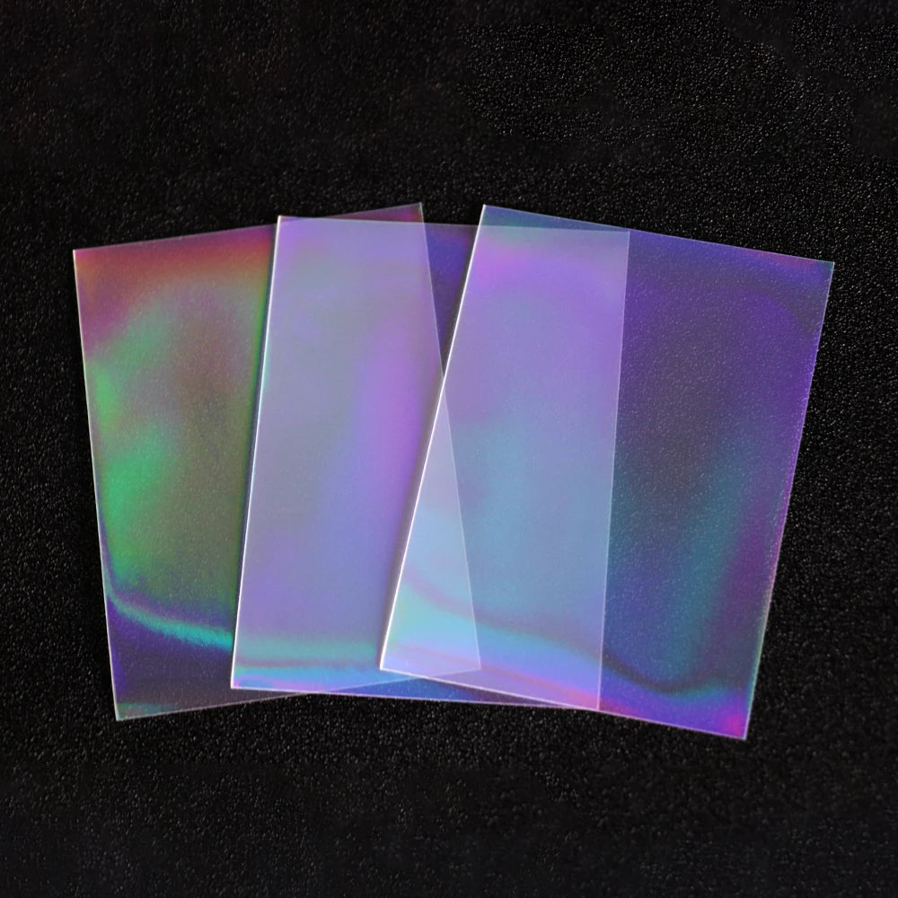 A stack of iridescent holographic card sleeves showing various rainbow and prismatic colors.