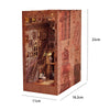A rectangular wooden bookshelf insert designed as a diorama with intricate carvings and warm LED lighting.