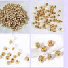 Various piles and arrangements of gold-plated brass round spacer beads for jewelry making