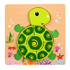 A bright green turtle puzzle set featuring a head and shell on a wooden background with small plants and colorful elements.