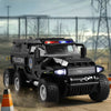 A black SWAT city police truck diecast toy with lights and sounds driving on a dirt road.