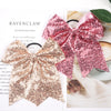 Pink and rose gold glitter sequin pigtail bows for girls displayed on a white background.