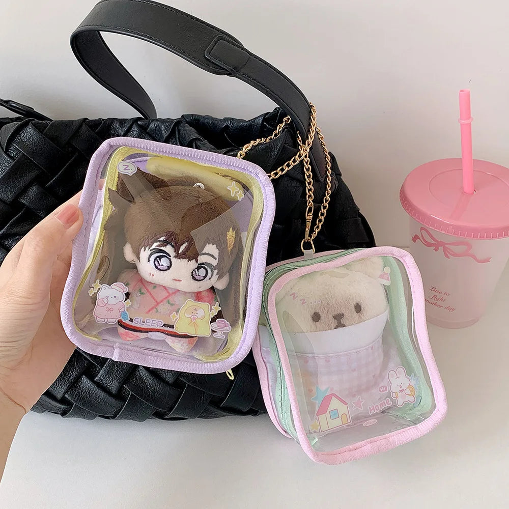 A pink storage pouch with a keychain featuring a cute doll inside, displayed next to a pink drink cup.