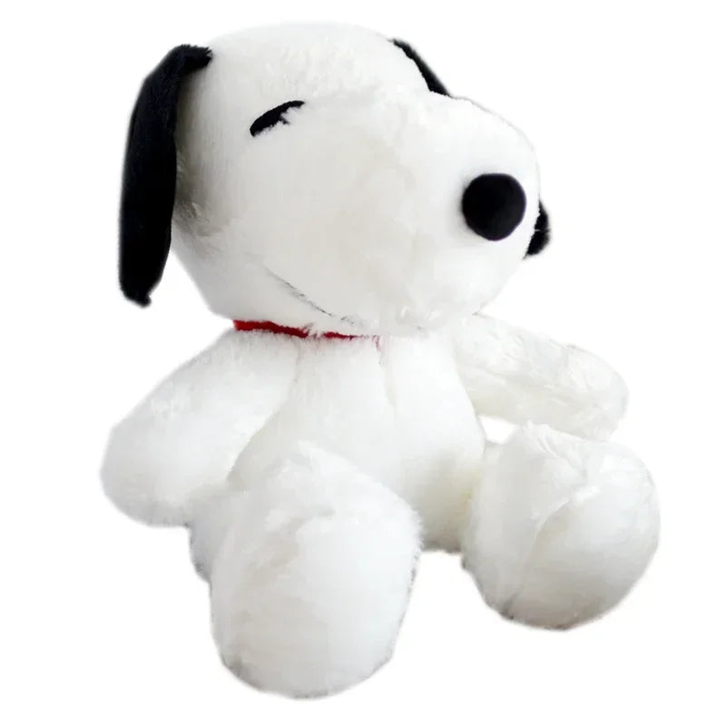 A white Snoopy cartoon plush toy pillow with black ears and a smiling face.