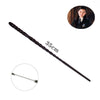 A long, thin, dark metal magic wand with a decorative tip and a circular inset showing its size.
