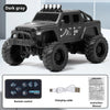 A black 1:64 scale off-road RC car with 4x4 features and a remote control, charging cable, and instruction manual.