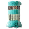 A set of six skeins of vibrant turquoise embroidery thread for cross stitch and DIY crafts.