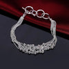 Elegant sterling silver snake chain bracelet for women displayed on a dark surface.