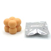 A pile of orange candle dye chips for soy wax, beeswax, and paraffin.