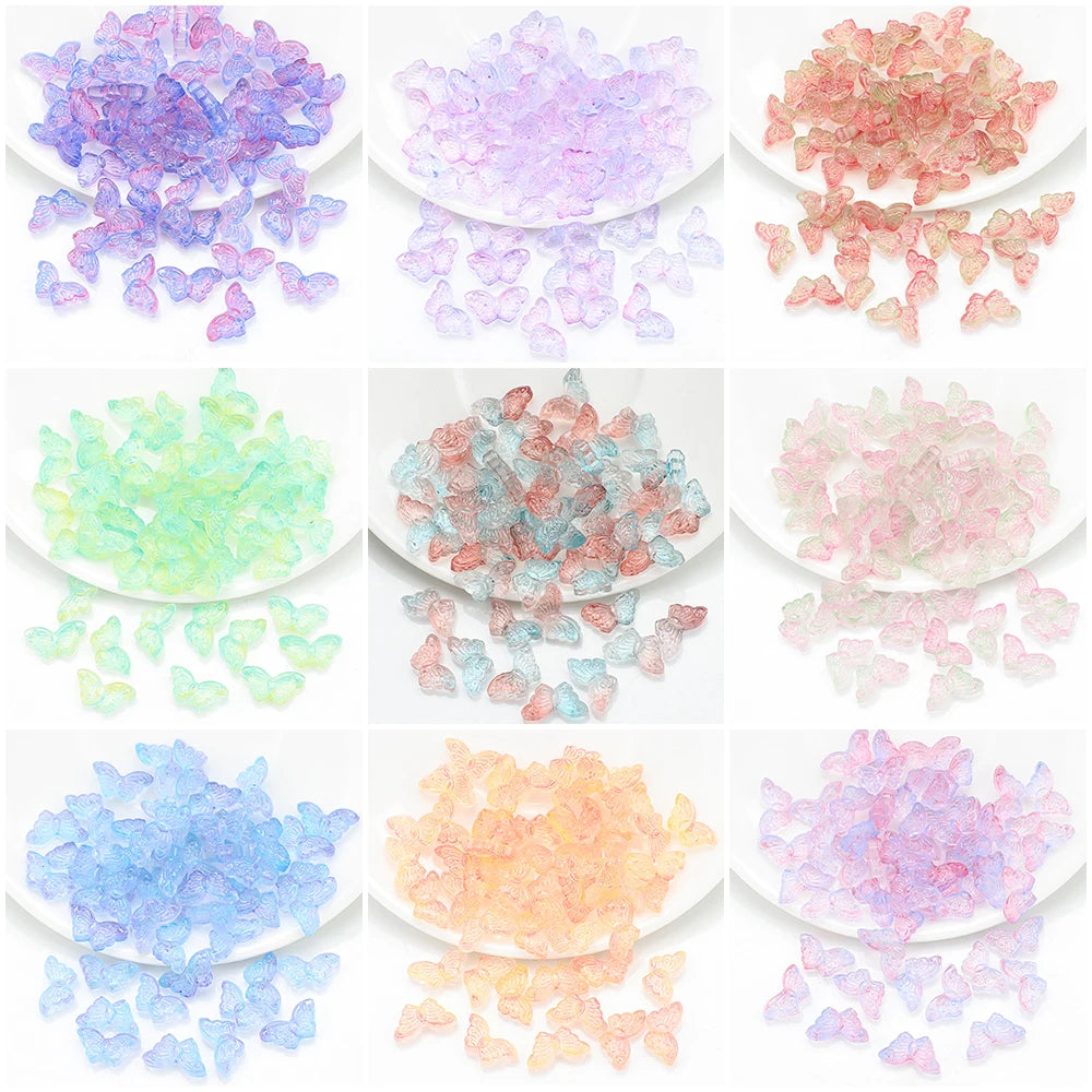 A collection of colorful glass beads in various shades including purple, pink, green, and blue scattered on a white backgroun