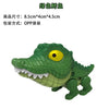 A green dinosaur fidget toy with movable joints, featuring a yellow eye and sharp teeth.