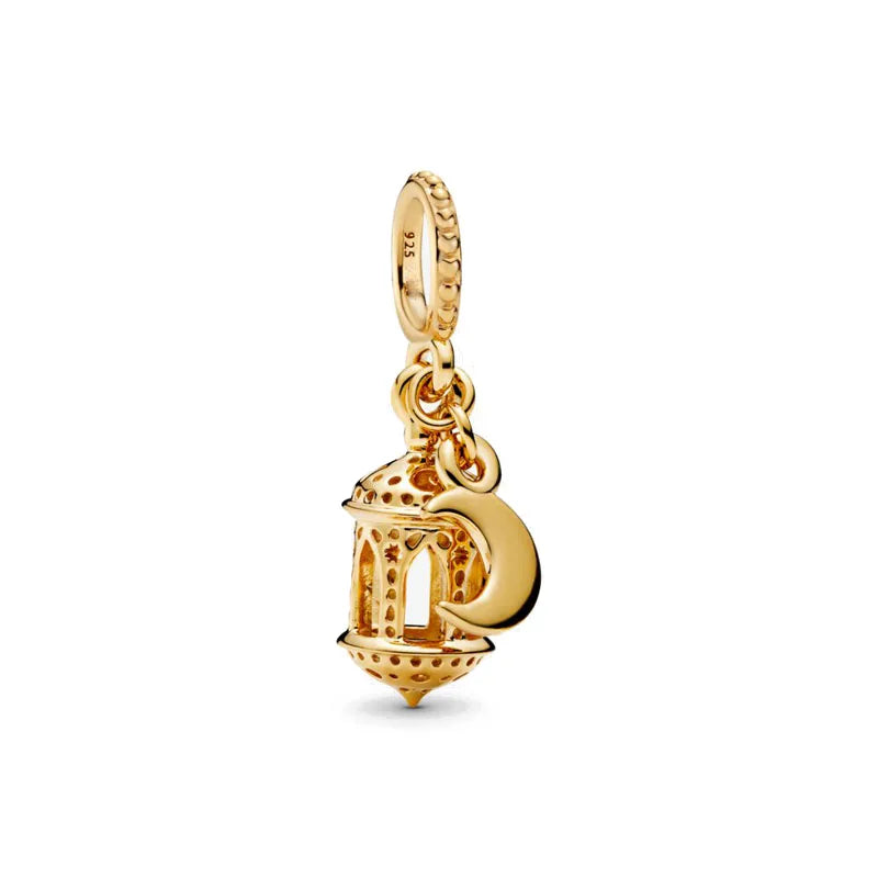 A gold-toned charm bracelet featuring pendants shaped like an elephant, key, butterfly, and heart.