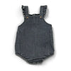 A dark gray denim romper with ruffled straps and patch pockets.