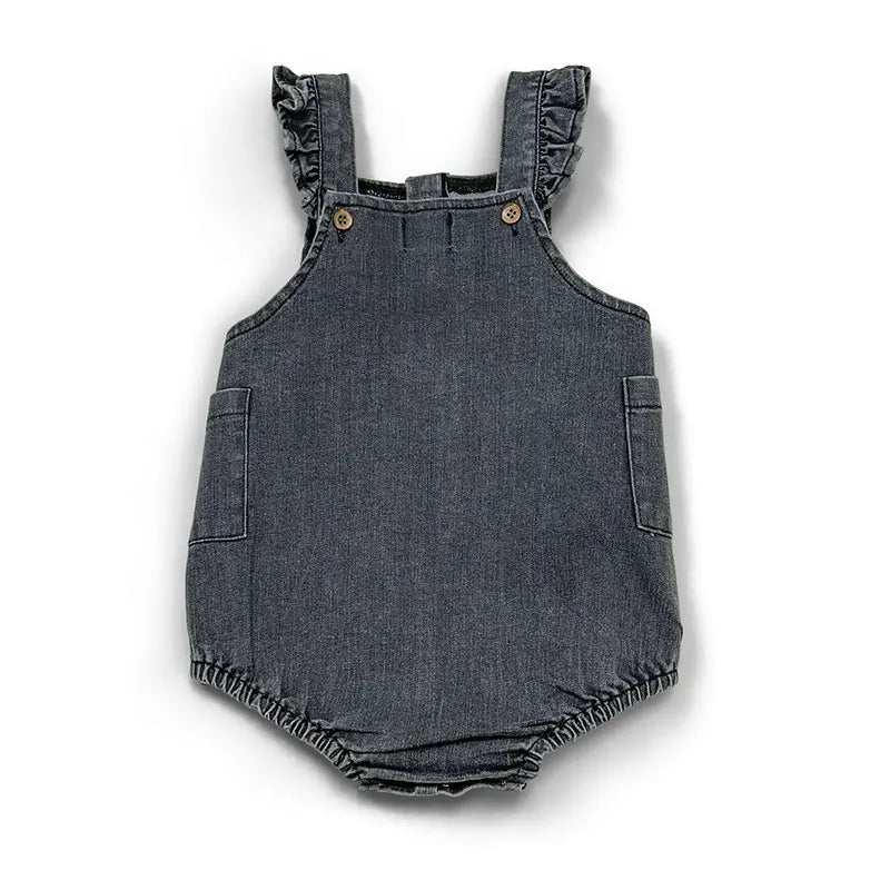 A dark gray denim romper with ruffled straps and patch pockets.