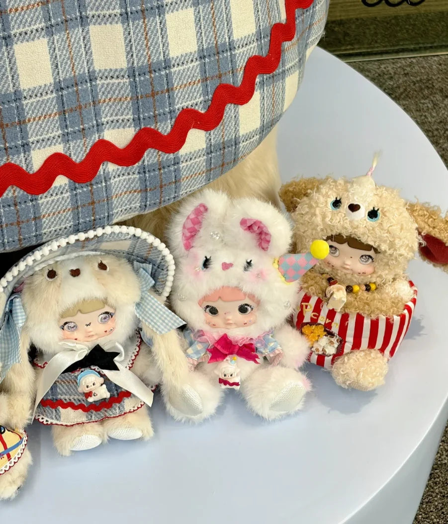 A close-up of Nommi Childhood Series blind box collectible dolls with fluffy fur and detailed clothing.