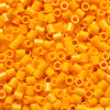 A pile of bright orange and yellow creative fuse beads for a craft kit.