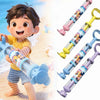 A young boy is playing with a blue rotating firework water blaster toy and several colorful versions of the same toy.