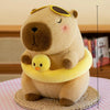 A soft brown capybara plush toy mother with four small yellow baby chicks.