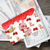 A sheet of cute strawberry and shortcake card stickers with a red drizzle design placed on top of paper money.